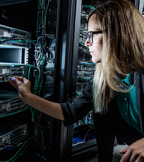 Woman working on it infrastructure in server rack